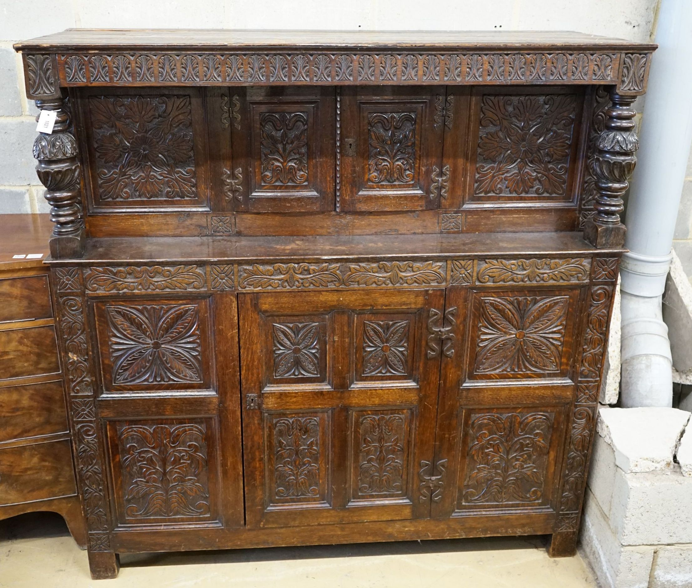 An 18th century style carved oak court cupboard, width 161cm, depth 54cm, height 164cm